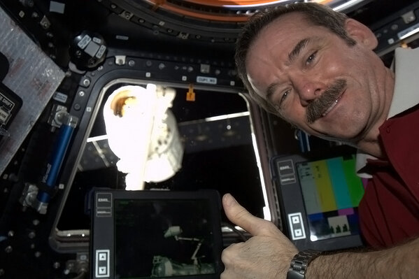 Cmdr_Hadfield's tweet photo. Happy crewmember - Dragon securely snared by Canadarm2, ready to be lifted around, hooked into place, and opened up. http://t.co/kEOGpvbjBY