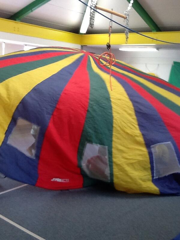 Sitting under a rainbow of color with Mrs. Monty. Mrs. Mattos Pre k class.