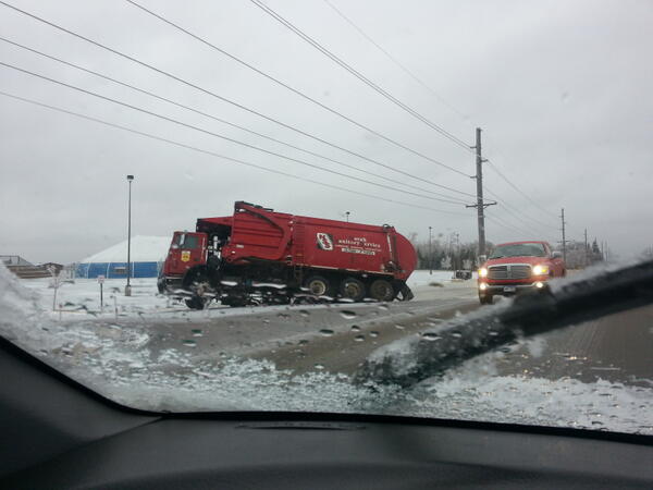 BoostedMonster's tweet photo. Garbage truck half tipped in the ditch at usf stadium off 69th and cliff http://t.co/KWZ7Zr25bE