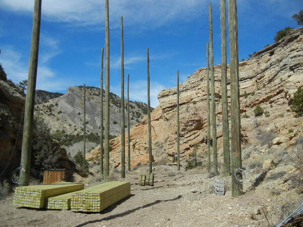Poles in place, lumber for platforms stacked, ready for #aerialpark #challengecourse construction at #zipline. WOW!