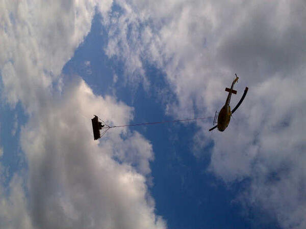 Wild1s's tweet photo. Rhino rescue in action. Yes, there is a Rhino in that sling! http://t.co/Fj2FSmKolF