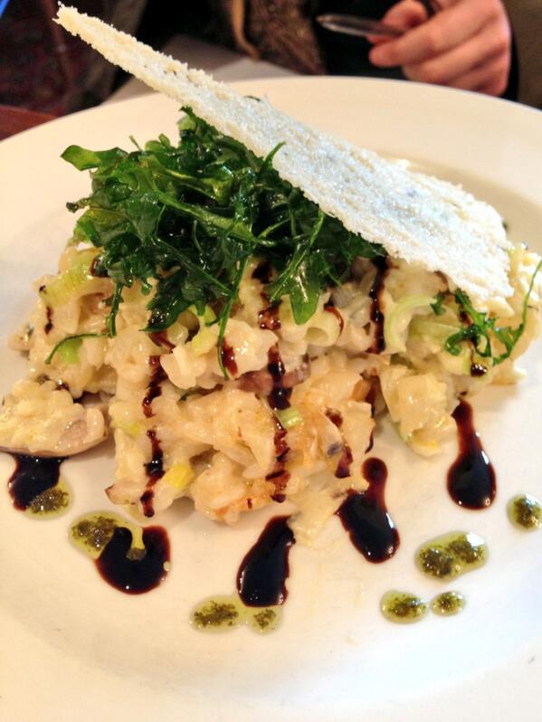 Buttered Leak and Mushroom Risotto (v) finished with deep fried rocket, basil oil and Parmesan crisp.