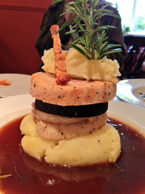 Braised Belly of Pork stacked with black pudding, set on apple mash with golden crackling and rosemary infused jus