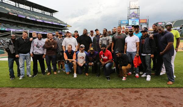 Broncos's tweet photo. Peyton Manning took several of his teammates to visit the @Rockies tonight. Here's a shot of the group on the field: http://t.co/fOfHpZsKFD