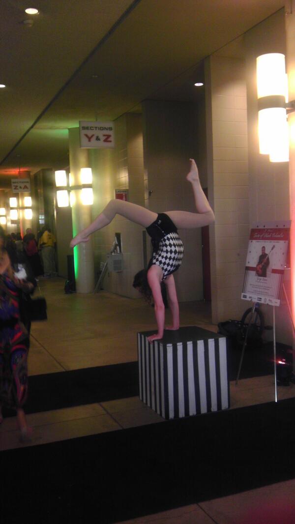 Rachel doing hand balance, contortion and juggling at Taste of Black Columbia.