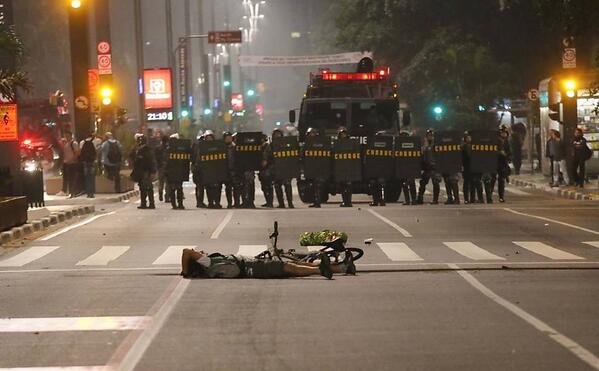 KetyBrazil's tweet photo. Cyclist on the ground in front of riot police during protest in Sao Paulo (Folhapress) http://t.co/Ze4eBsfIaa