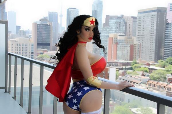 Amy Anderssen as Wonder Woman looking over her shoulder on a balcony.