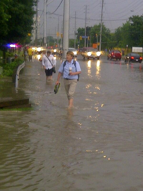 680NEWS's tweet photo. [PHOTO] Pedestrians walk in flooded streets near Dixie Rd. and Lakeshore Rd. Photo by 680News reporter Carl Hanstke. http://t.co/S8xUAC1PbN