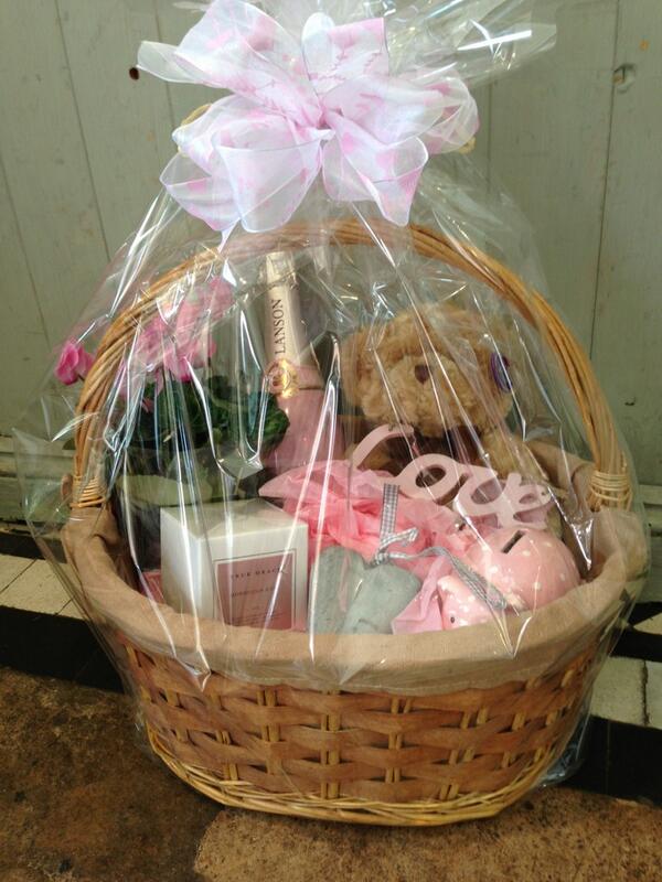 Luxury baby girl gift baskets available include Lanson champagne and beautifully scented true grace candles.