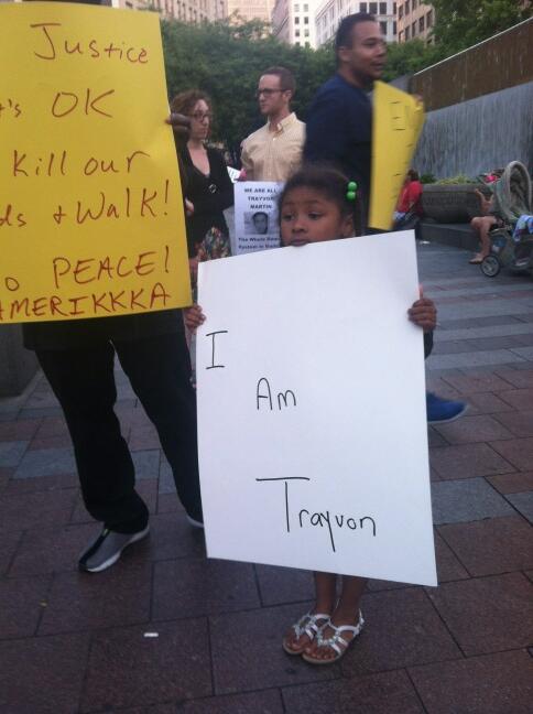 Ava, 5, holds a poster saying "I am Trayvon" Sunday at Seattle's Westlake Park.