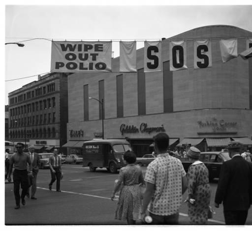 16th and Farnam Street looking Northeast.  Banner reads: "Wipe Out Polio."  1962 #Omaha