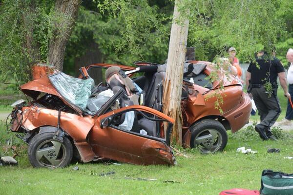 in between a telephone pole and a tree. the car was not a convertible before the accident, lol.