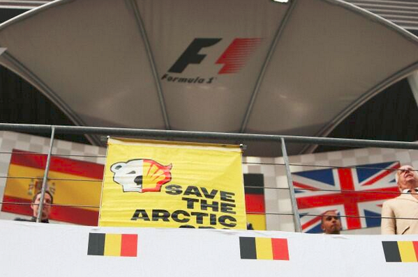Greenpeace's tweet image. Wondered why everyone was looking up? Protesting @Shell's Arctic drilling above the winner's podium #FormulaShell