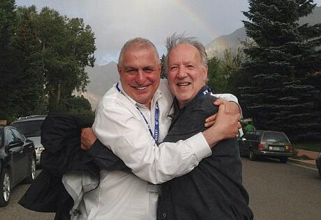 LWLies's tweet photo. Werner Herzog and Errol Morris hugging. The rainbow in the background is nature celebrating their friendship. http://t.co/l7JUhXJJ0U