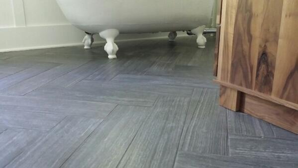 6x24 porcelain layed in #herringbone #design #clawfoot #tub