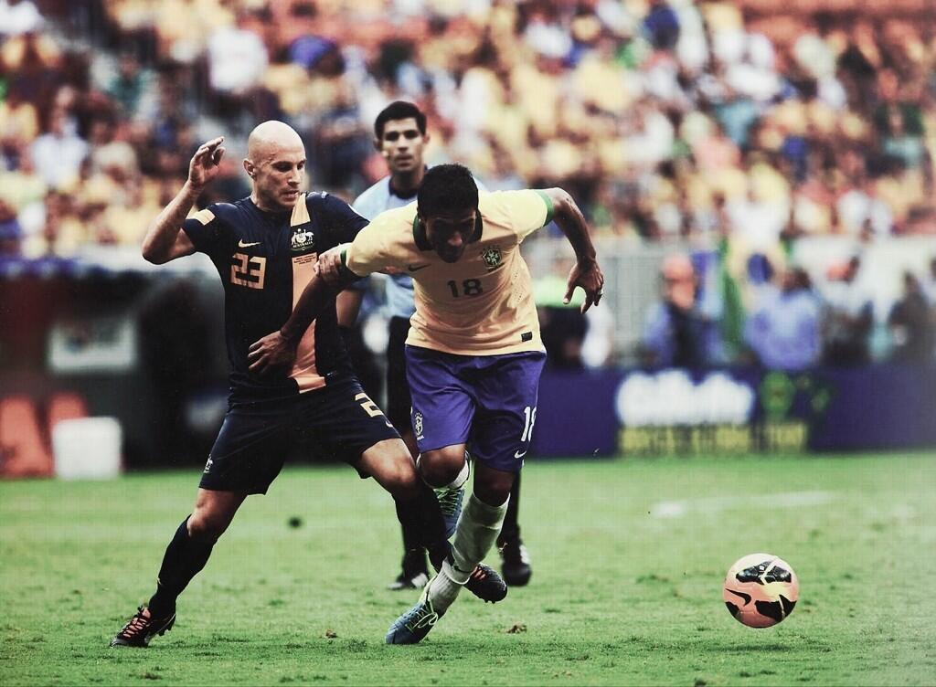 Paulinho beats Bresciano to the ball in a typical feature of the night's game - Brazil beating Australia. 