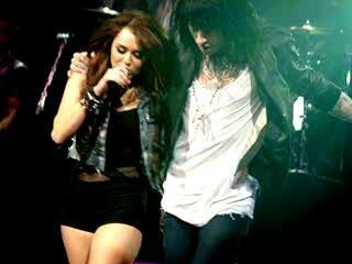 A picture I got of <a href="/mileycyrus/">Miley Cyrus</a> + <a href="/tracecyrus/">Trace Cyrus</a> at the Wonder World tour