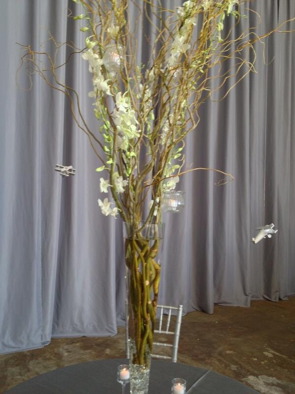 Julieluvsbrides's tweet photo. Hawaii themed table. Notice the little candles and airplanes hanging from the orchid adorned branches! http://t.co/tapRoYO1oh