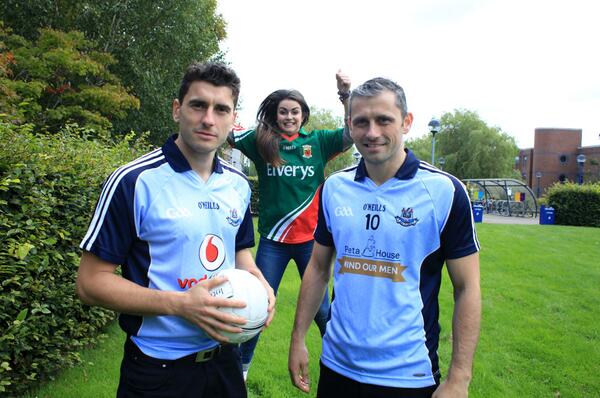 GOAL_Global's tweet photo. Mayo fan Lorna Finnegan sneaking up on Bernard and Alan Brogan in DCU this week!  #GOALJerseyDay #AllIreland http://t.co/tCjcKUcszb