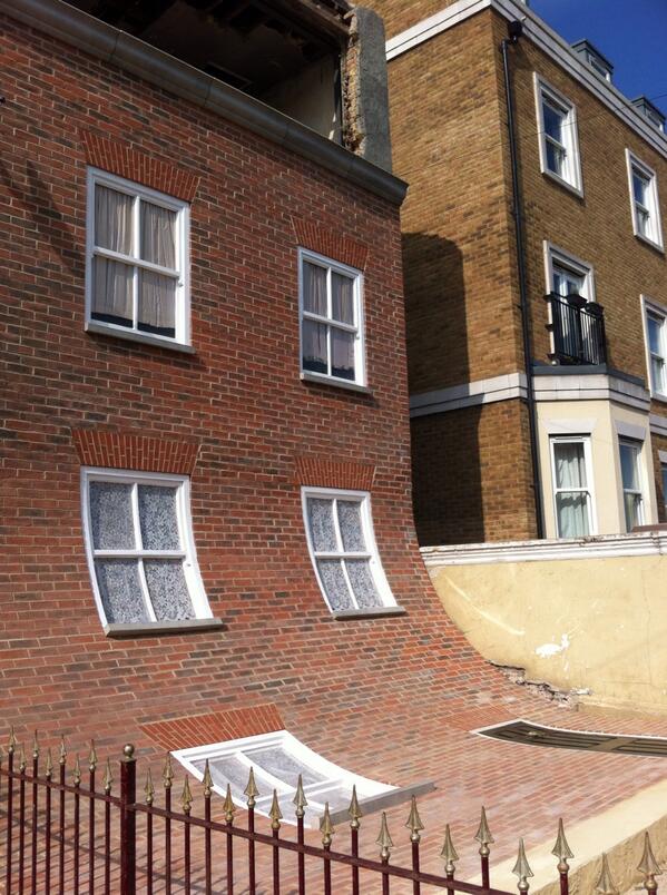 TCMargate's tweet photo. We're at opening Alex Chinneck's outdoor sculpture in Godwin Road-the front of the house has slipped down! Come see http://t.co/lNv35tZMDa