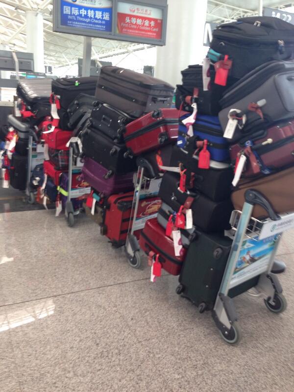 NSPNikal's tweet photo. The Chinese guy in front of me at the airport thinks he can do a 'carry on with his bags' He's having a laugh! http://t.co/ES2cbvBZjp