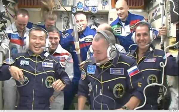 esa's tweet image. All 9 crew of #Exp37 and #Exp38 together with #OlympicTorch  aboard #ISS