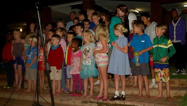 Young children gather to sing "Away in a Manger" at the Carols by Candlelight service on Friday evening.
