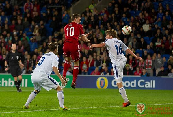 Photo: Wales' Andy King heads in the opening goal against Finland. #WalvFin