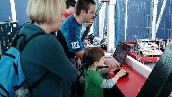 Mentor Nate showing a future imagineer how to control Bluabot that we made over the summer