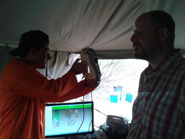 RisingStarExped's tweet photo. . @krugzz cleaning and testing the scanner on @johnhawks after a long day of fossil excavation #risingstarexpedition http://t.co/5iabkCutft