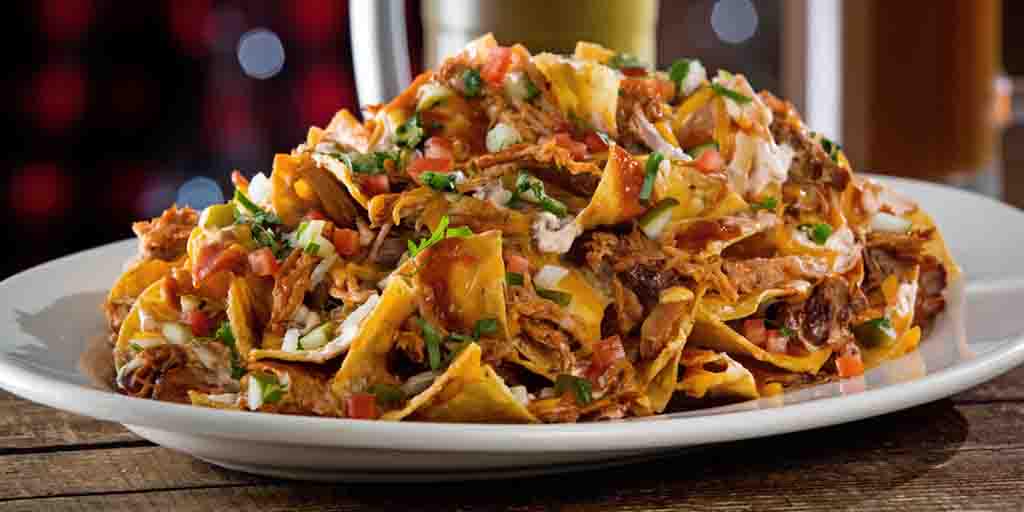 Why party at the boring sports bar? Even our nachos are more fun. #BBQPulledPorkNachos #Mmm #MarchWisdom