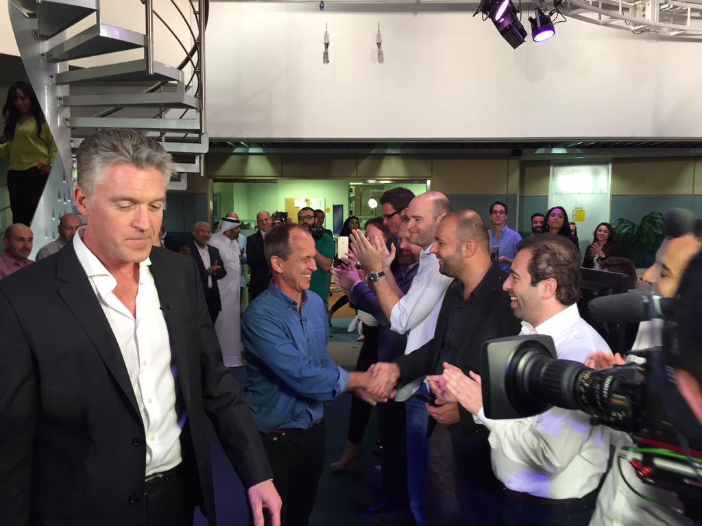 quinnynews's tweet photo. AJE MD @AlAnsteyAJ leads @PeterGreste into the Doha newsroom lined with colleagues delighted to see him #FreeAJStaff http://t.co/O2HhrslpIV