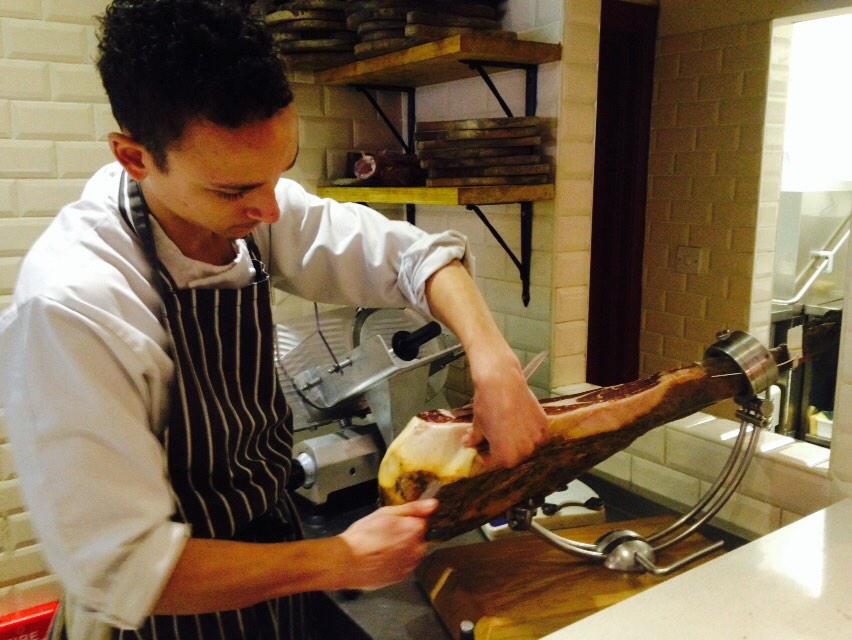 olivemagazine's tweet photo. 'Haminista' Tom @tapaspenarth slicing jamon iberico for us! http://t.co/R6HdeQdYti