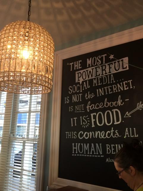 chandelier and blackboard with some stuff about social media and food written on it