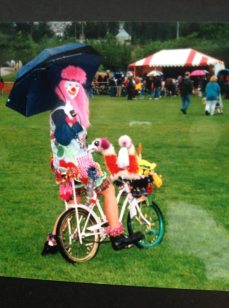 skiwithsparkles's tweet photo. #TBT  Sparkles a few years back at a rainy summer festival.The bike &amp; the umbrella, it's a lot going on! #clown#love http://t.co/1BdjNGxnV4