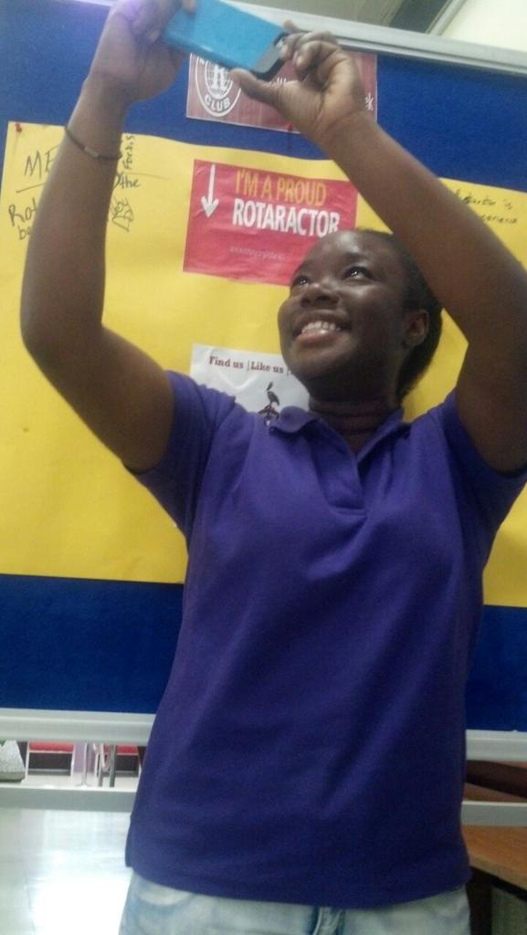 RotaractUWIMona's tweet photo. Dir @Abbz_widoutdabs caught taking a selfie with the display boothe in the main library #HappyWorldRotaractWeek http://t.co/StdQOvYezo