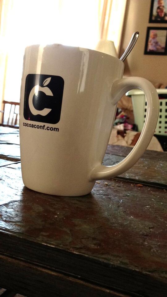 jeremyefox's tweet photo. Rocking my shiny new @cocoaconf coffee cup. http://t.co/TxjQUUKRdA
