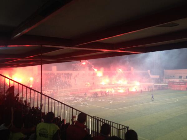 AndyFraserSport's tweet photo. In Algeria, for example, it's common for fans to throw flares like this. Punishment = next match behind closed doors http://t.co/ZFAdfOYFN8