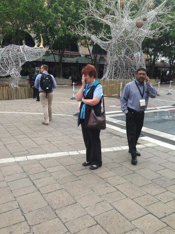 missbolani's tweet photo. This lady is praying after laying followers at tribute site at Nelson #Mandela Square in Sandton #SABCNews http://t.co/1duRmDPzlu