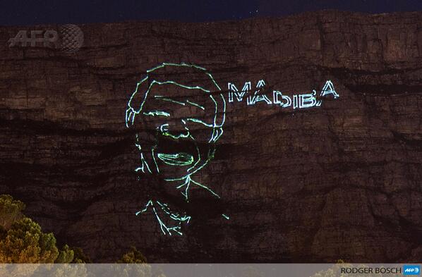 helenzille's tweet image. PHOTO: A laser light installation shows the face of Nelson #Mandela shining on Table Mountain in Cape Town  #Madiba