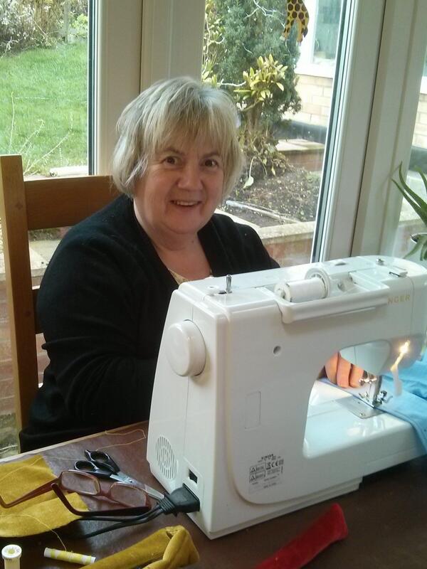 Susan busy making outfits for children coming to The Crib Service at 4pm on Christmas Eve.