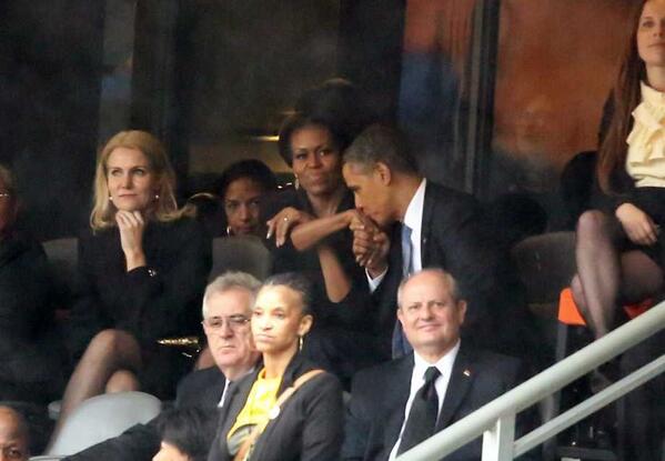 Obama kisses Michelle Obama's hand at Nelson Mandela memorial