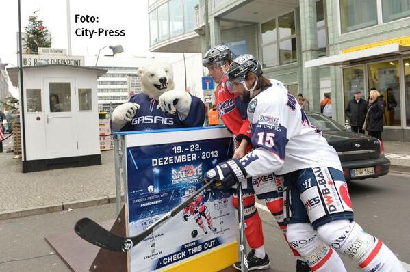 Two <a href="/Eisbaeren_B/">Eisbären Berlin</a> players check each other into the boards right at Checkpoint Charlie at downtown Berlin #etfinals13