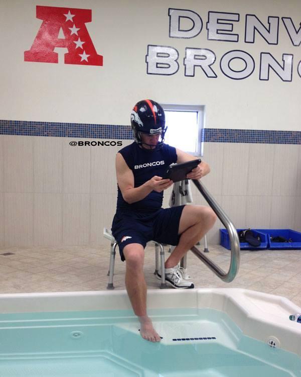 espn's tweet photo. Helmet on.
Gametape on iPad.
Ankle soaking.

This is how Peyton Manning spends his downtime. http://t.co/rm27Rwgoa7