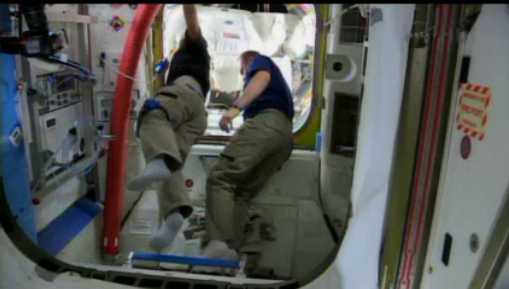 NASA's tweet photo. #Exp38 Wakata &amp; Kotov prep for the #spacewalk in the Quest airlock w suited crew behind them ready for depress:   http://t.co/z2GjEVMRmM