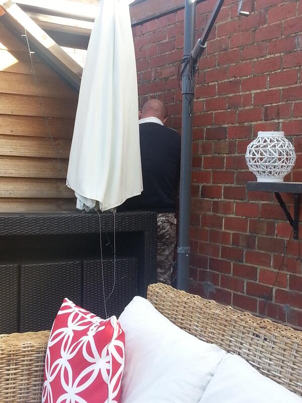 Q:what is @batemanhawk doing wedged in a cnr of his backyard?A:Impersonating gunsnroses lead guitarist. #modelparent