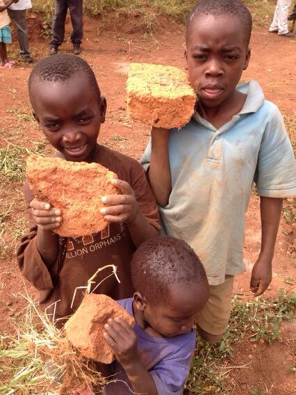 Community contribution! Kids are strong making way for the drill truck! #safewater #washprojects #uganda