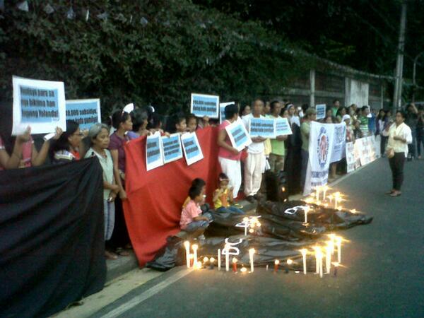 Tindog_PKK's tweet photo. Candle Lighting of #YolandaPH survivors and Church people along E.Rodriguez vs BS Aquino's neglect to typhoon victims http://t.co/uKRQc7iHjW