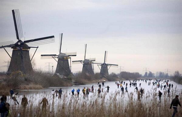 People skate on frozen canals in Kinderdijk's Mill Area, near Rotterdam,
 The Netherlands.