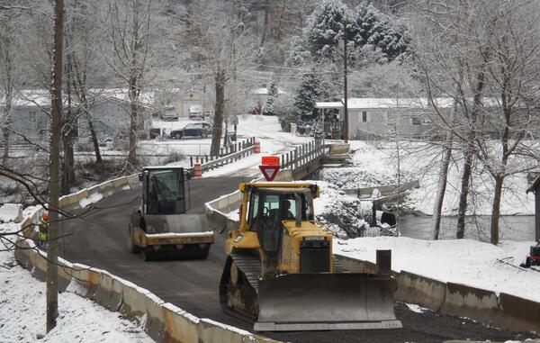 WVDOT's tweet image. Construction of a temporary causeway crossing the Guyandotte River at Madison Creek is complete and open to traffic!